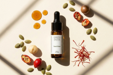 Seed Glow Face Oil surrounded by pumpkin seeds, rosehips, saffron threads and drops of golden oil
